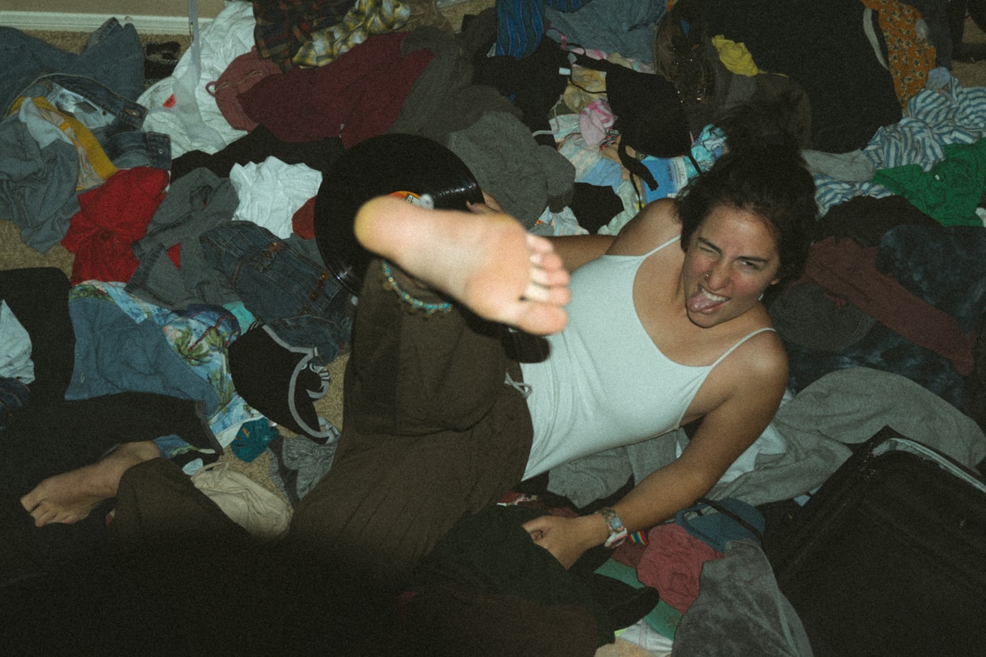 Woman sorting through a pile of clothes