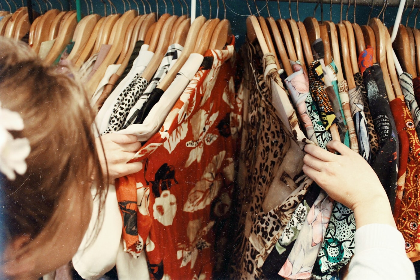 Person holding an armful of assorted clothes