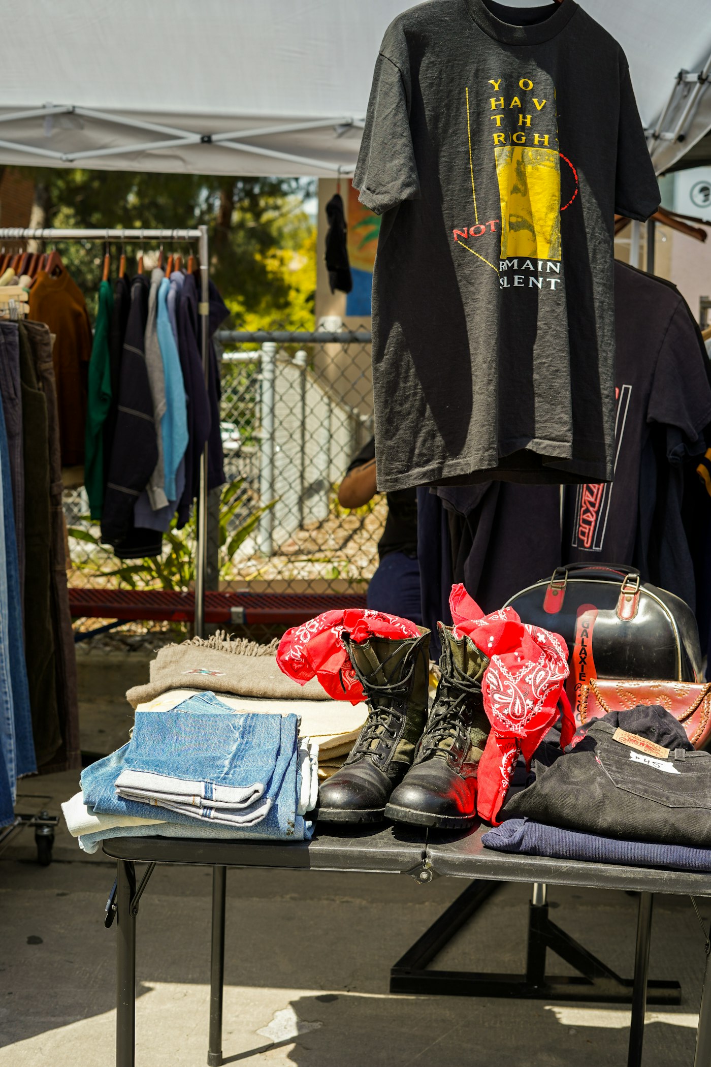 Table covered with secondhand clothes at a market