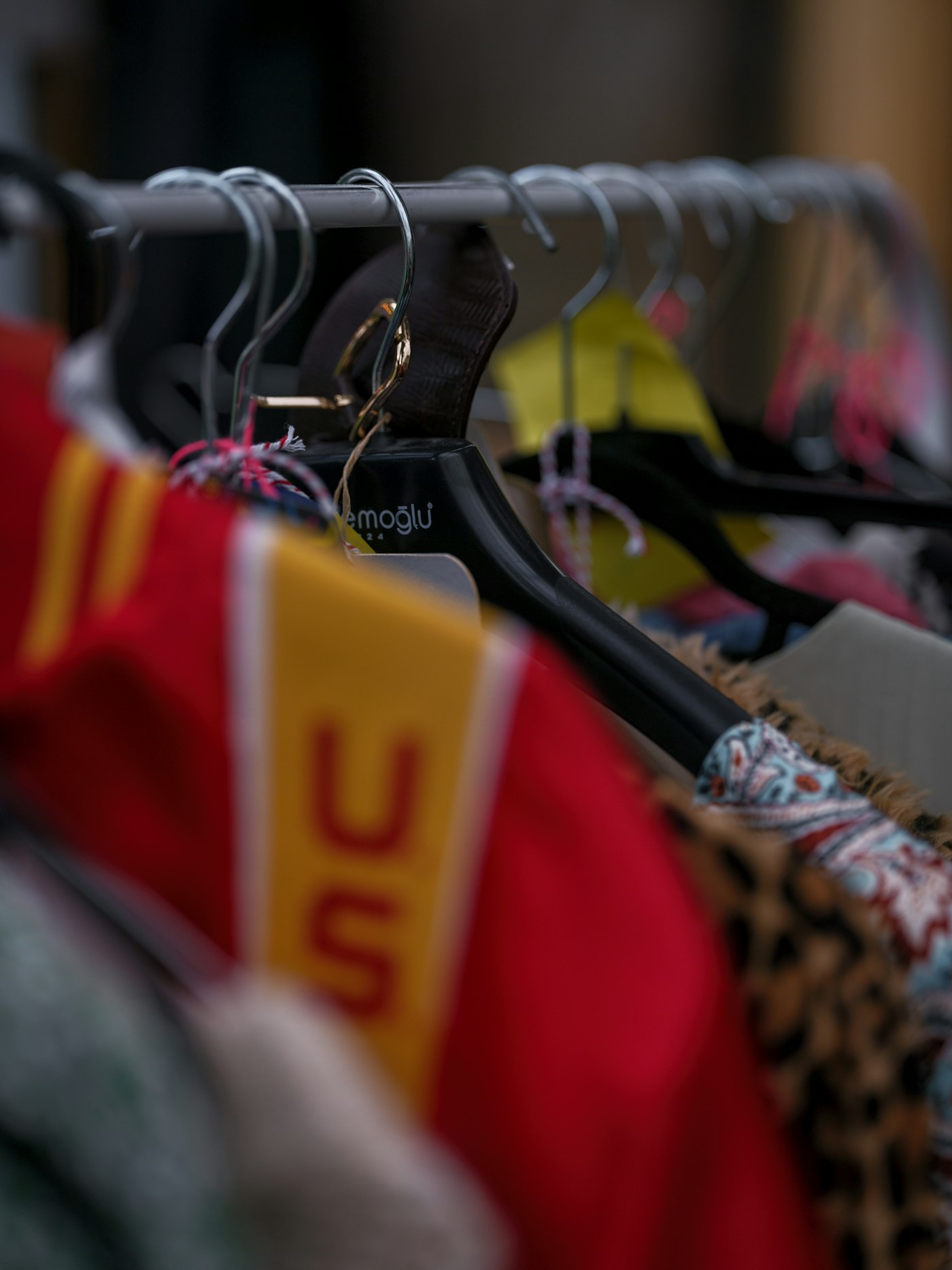 Colourful garments on hangers, flash